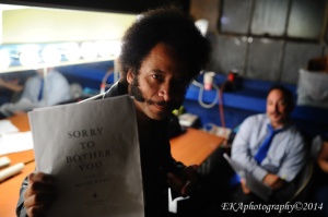 Boots Riley holds up a copy of his screenplay